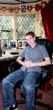 Ciaran Brown sitting at Sir Patrick's desk in his study